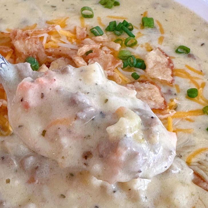 Spoonful of Cheeseburger Soup over a pipping hot bowl of the same.