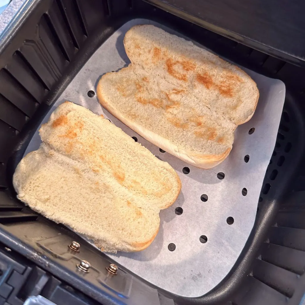 Toasted Air Fryer buns in the air fryer basket.