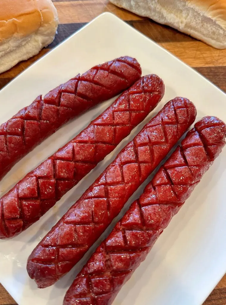 Hot Dogs cooling on a plate.