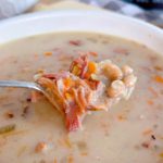 Spoonful of Navy Bean Soup over a big bowl full of same.