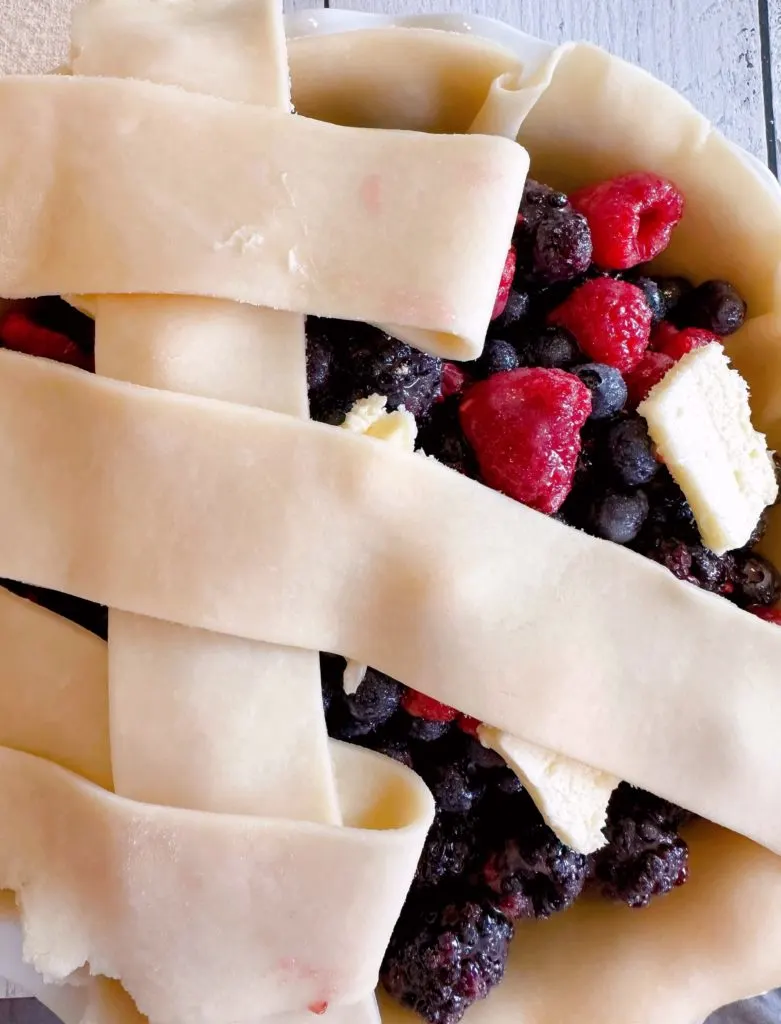 Strips of pie crust laid across the top of the pie for the lattice crust top.