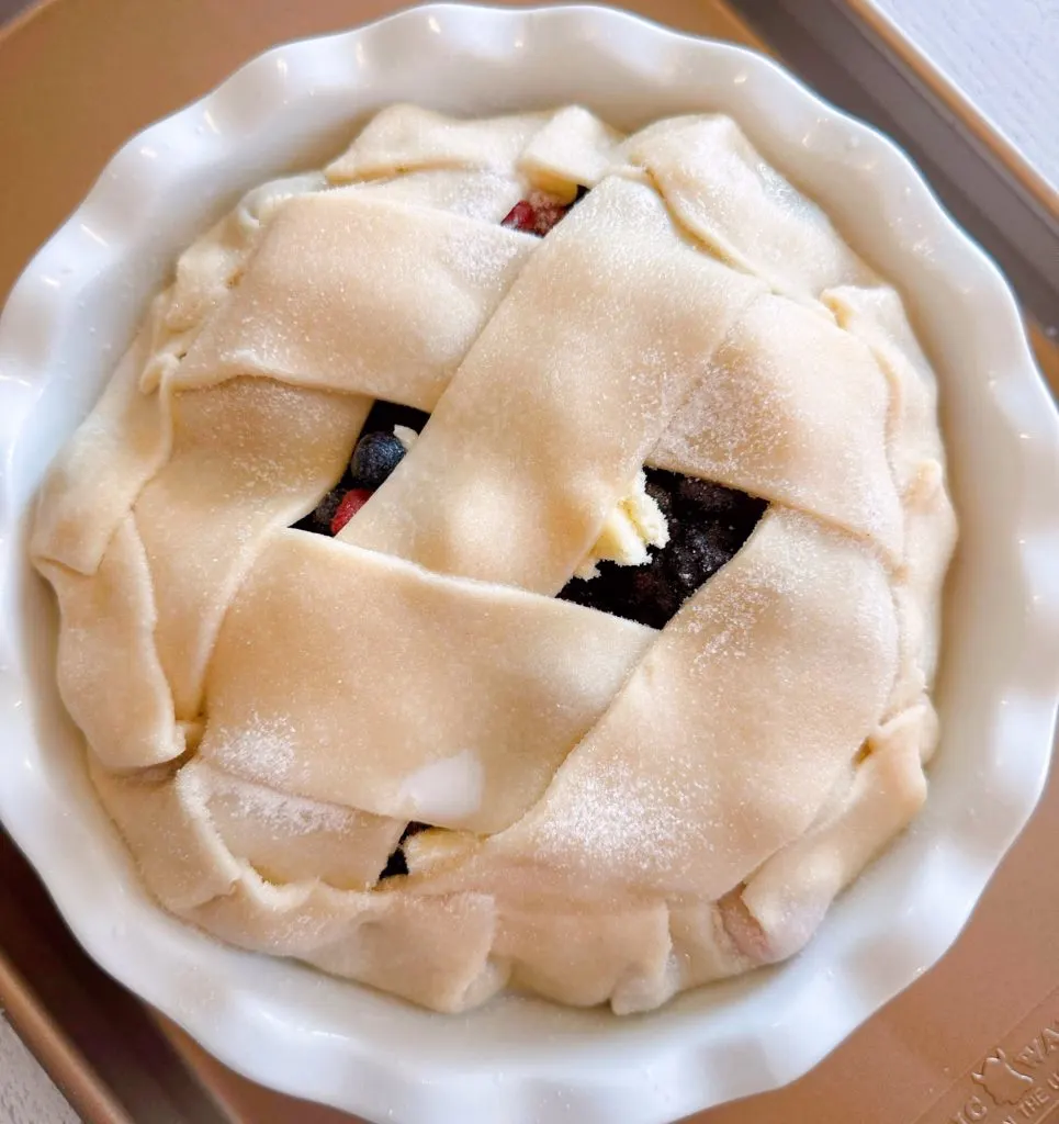 Pie on a lined baking sheet ready to go into the oven.