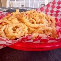 Easy Onion Strings in a red burger basket with checkered paper.