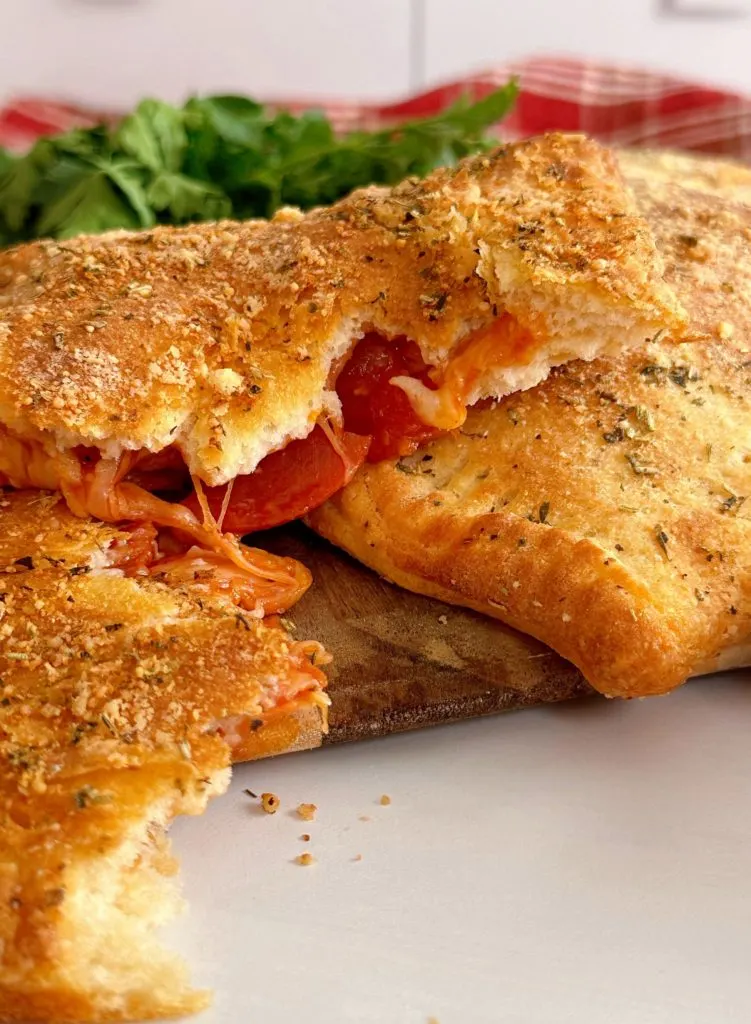 Close-up photo of Air Fryer Calzone split apart with pepperoni and cheese.