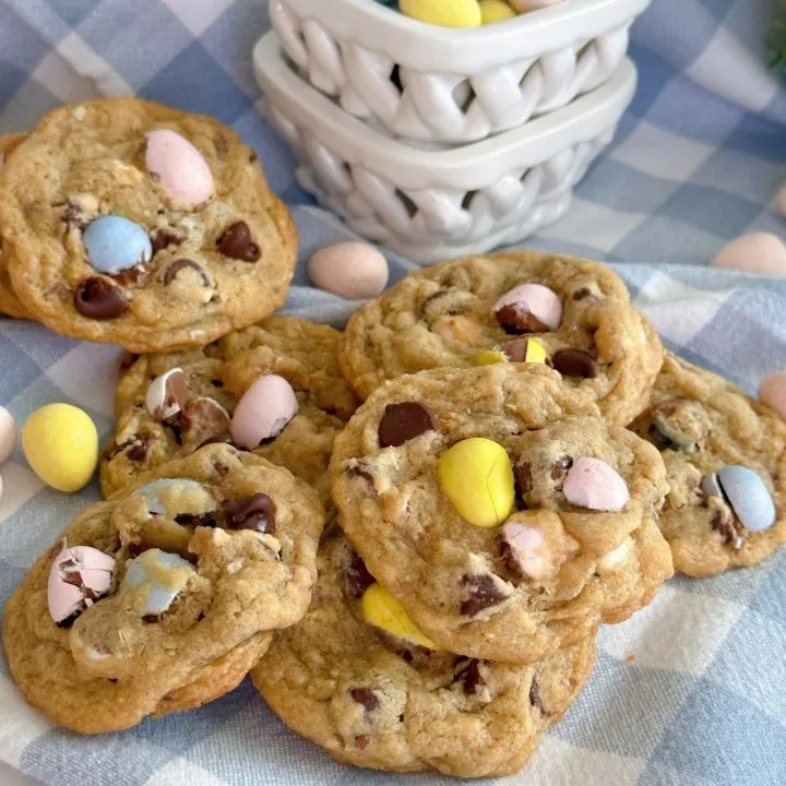 Mini Cadbury Egg Chocolate Chip Cookies in a pile on a linen napkin.
