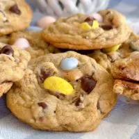 Pile of Cadbury Egg Chocolate Chip Cookies on a blue and white plaid napkin.