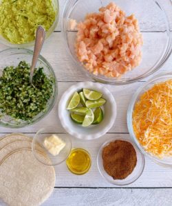 Ingredients on a white board for chicken skillet tacos.