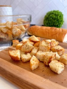 Homemade Skillet Croutons in a bowel and on a cutting board.