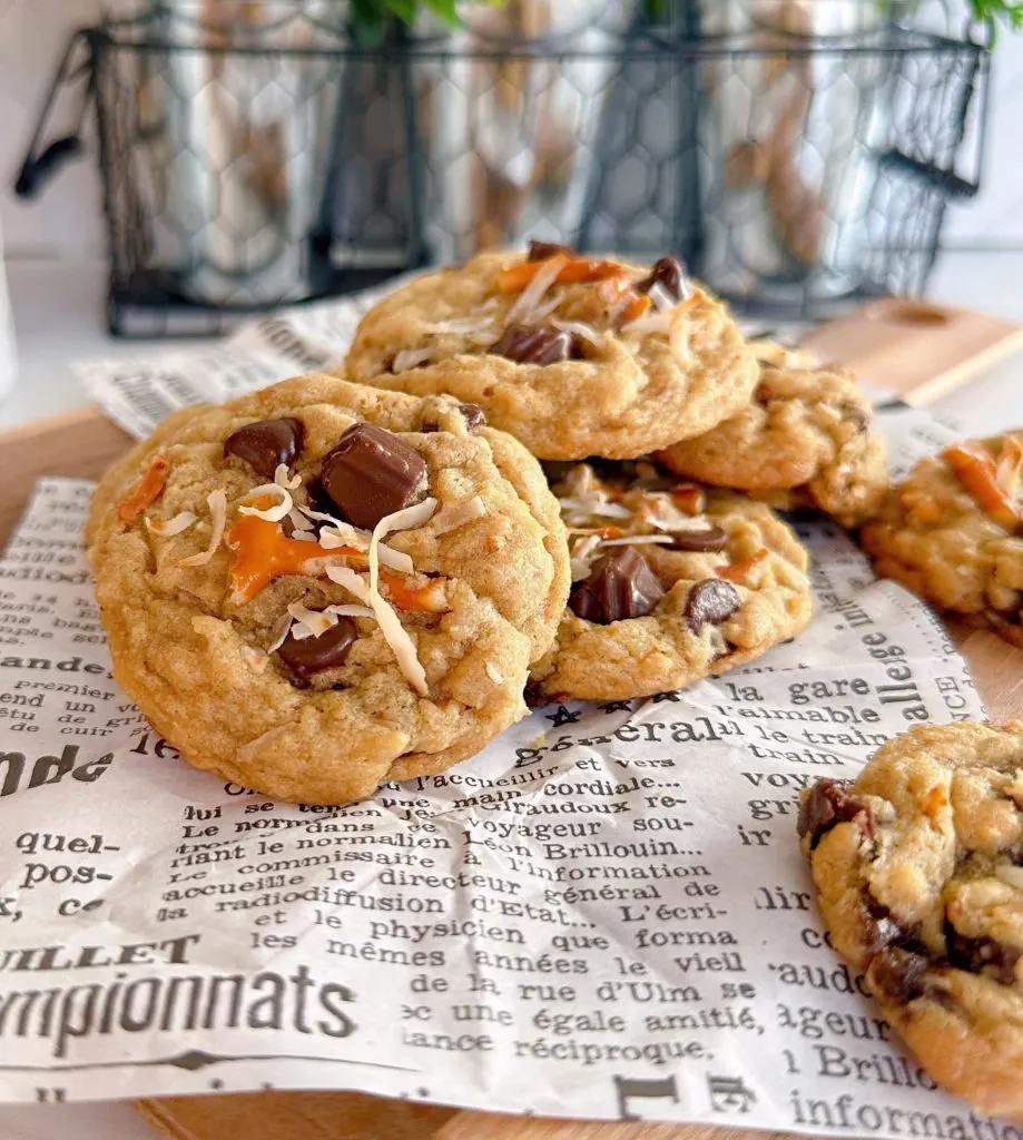 Stack of Ultimate Loaded Trash Can cookies on a piece of news print ready to eat.