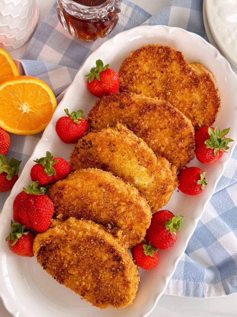 Platter full of Crispy Cinnamon French Toast with fresh strawberries.