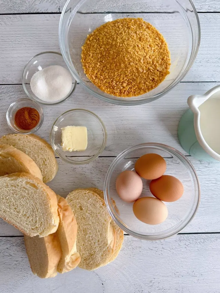 Ingredients for Corn Flake French Toast on a white board.