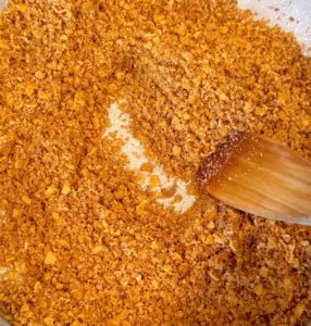 Cornflake mixture in a large skillet over medium heat toasting.