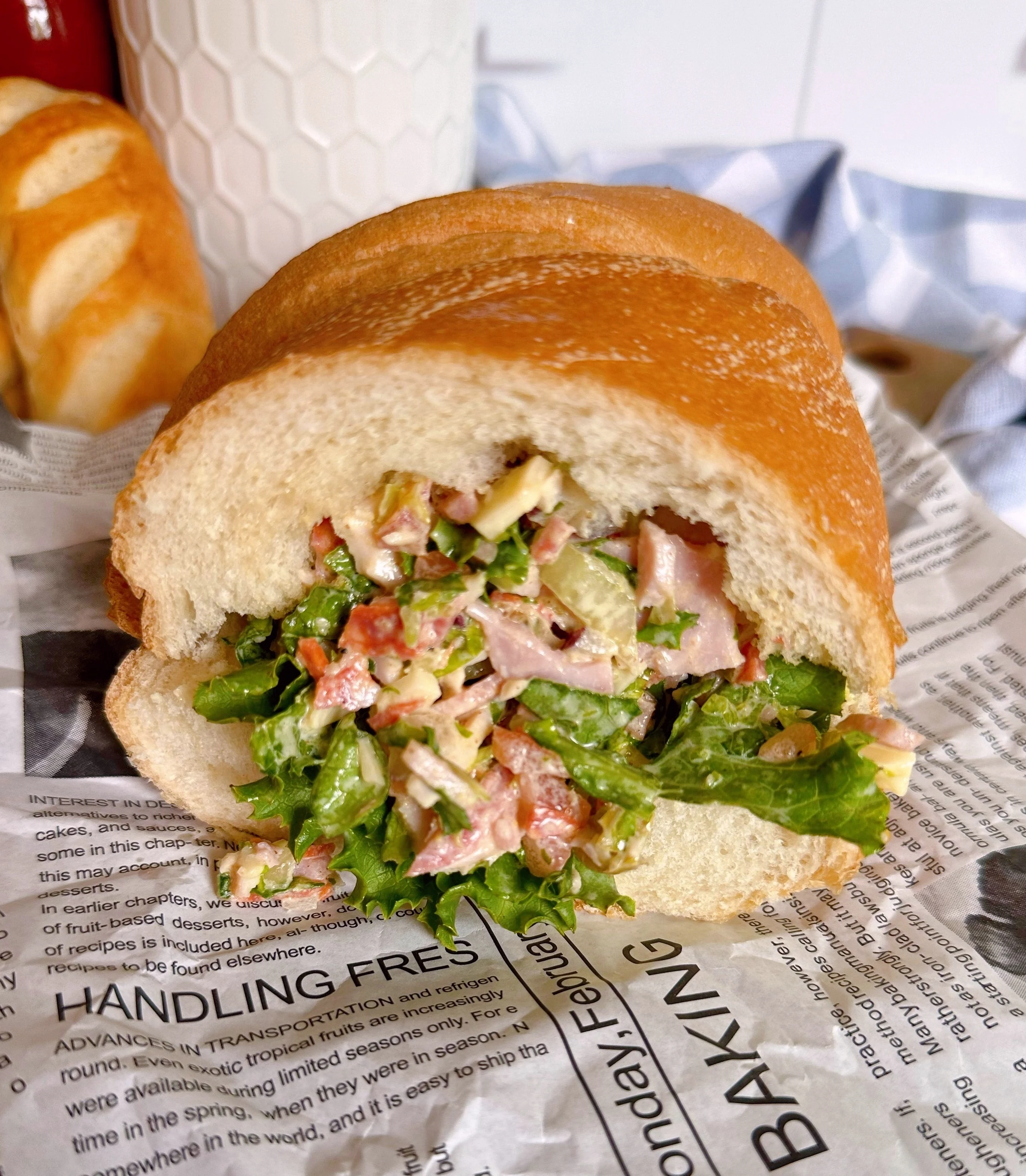 Chopped Italian Grinder Sandwich Recipe on a piece of news paper wrap.