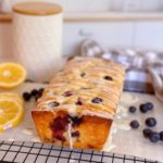 Freshly glazed Lemon Blueberry Bread on cooling rack.