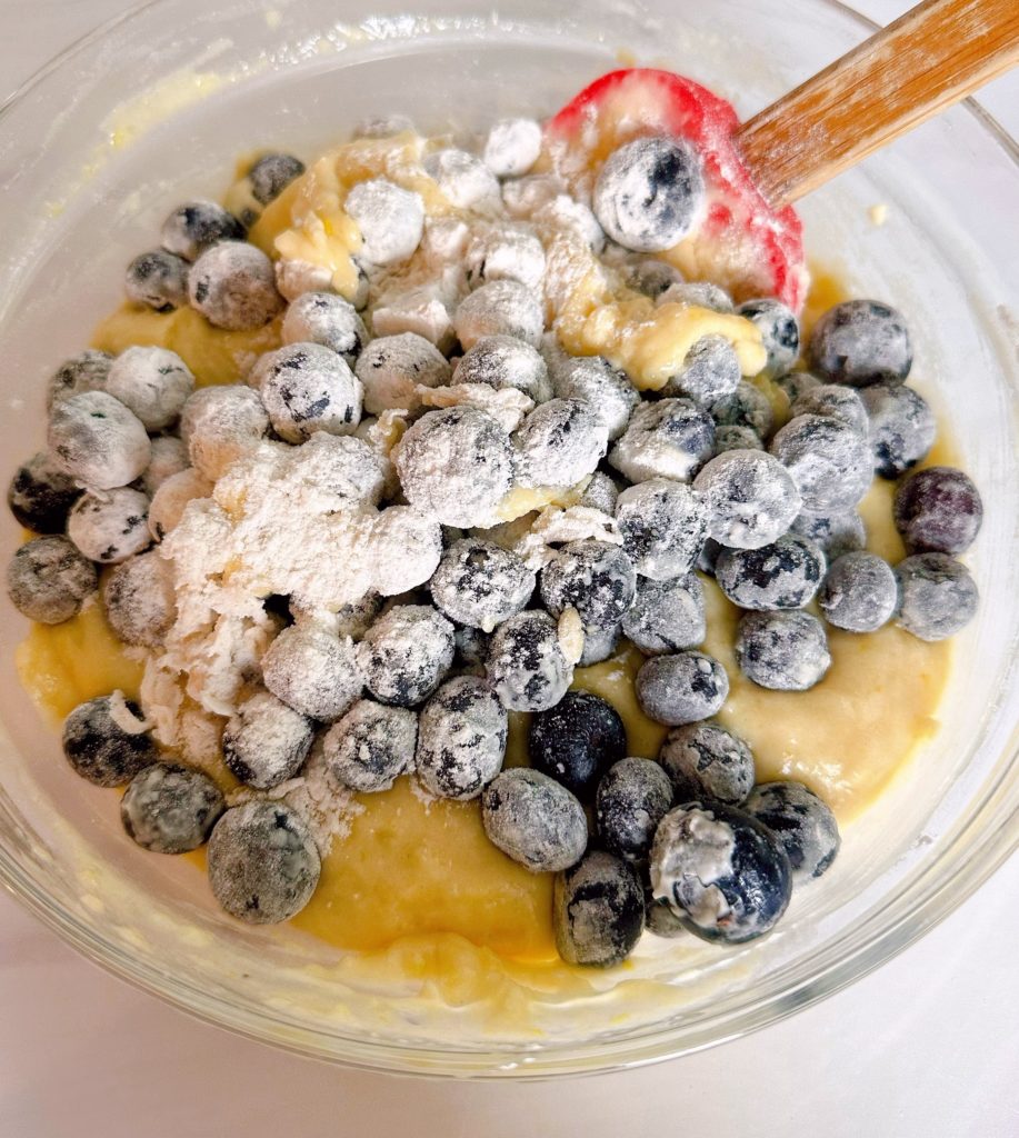 Folding blueberries into lemon bread batter.