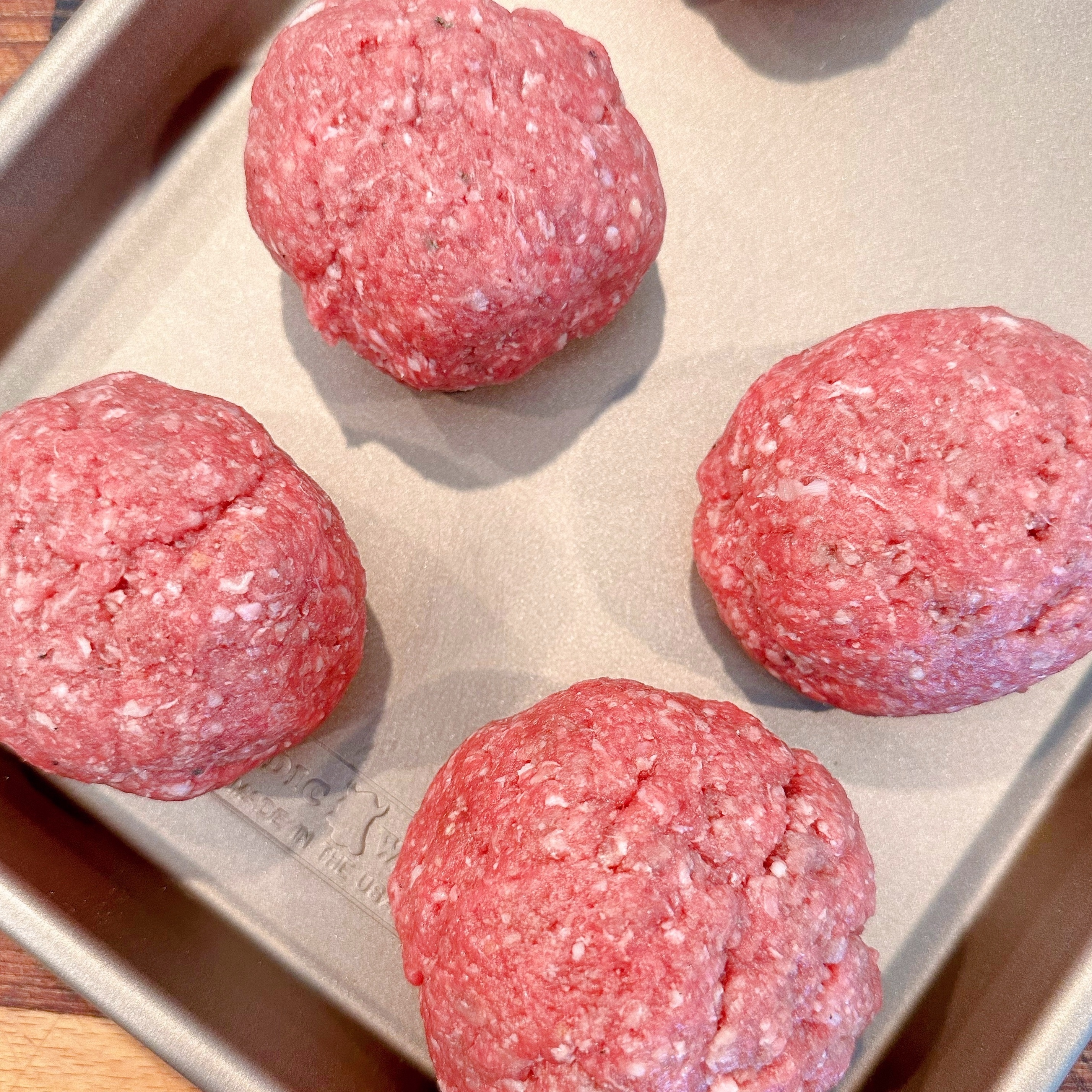 Ground chuck formed into balls for the smash burgers.