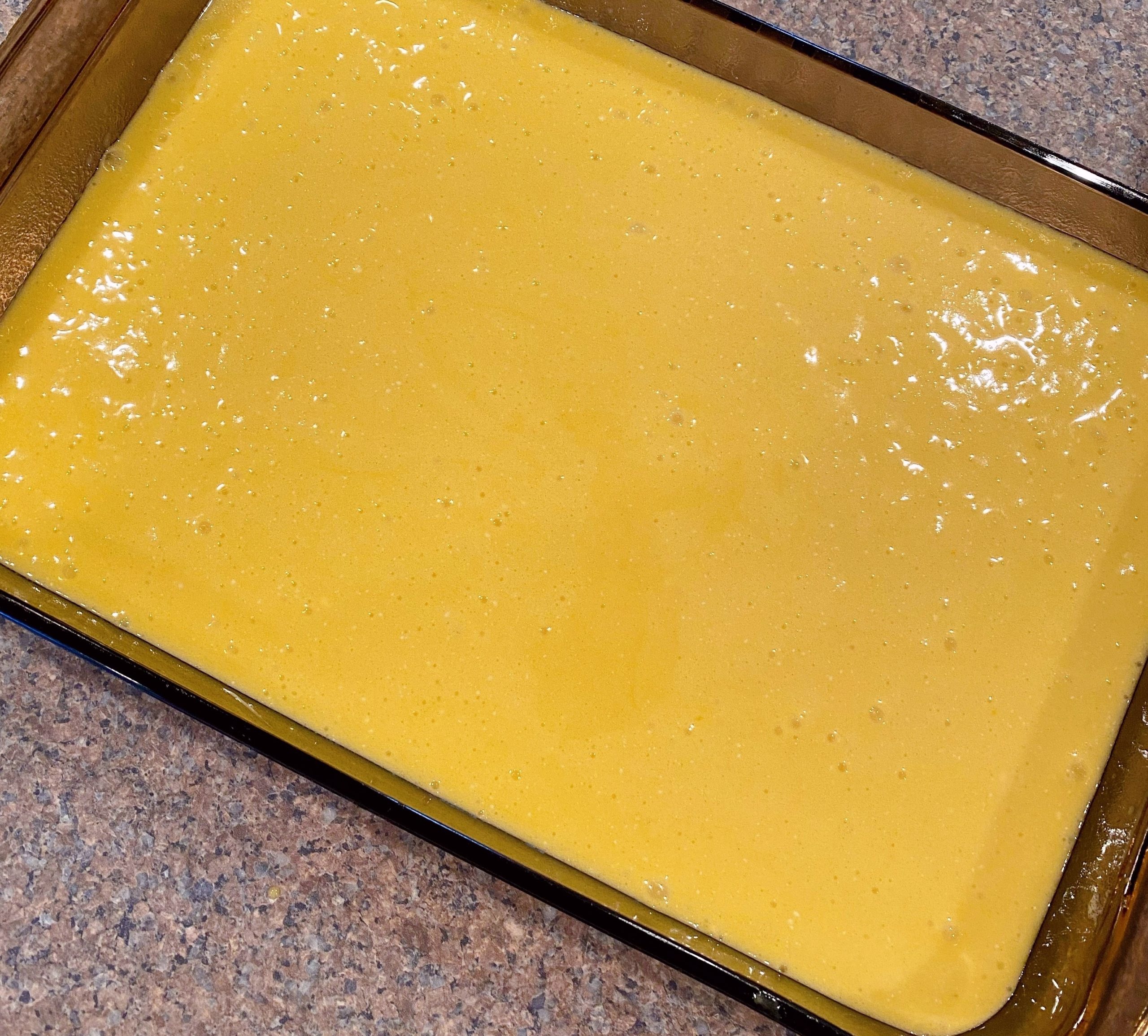 Cake batter poured into prepared cake dish. 