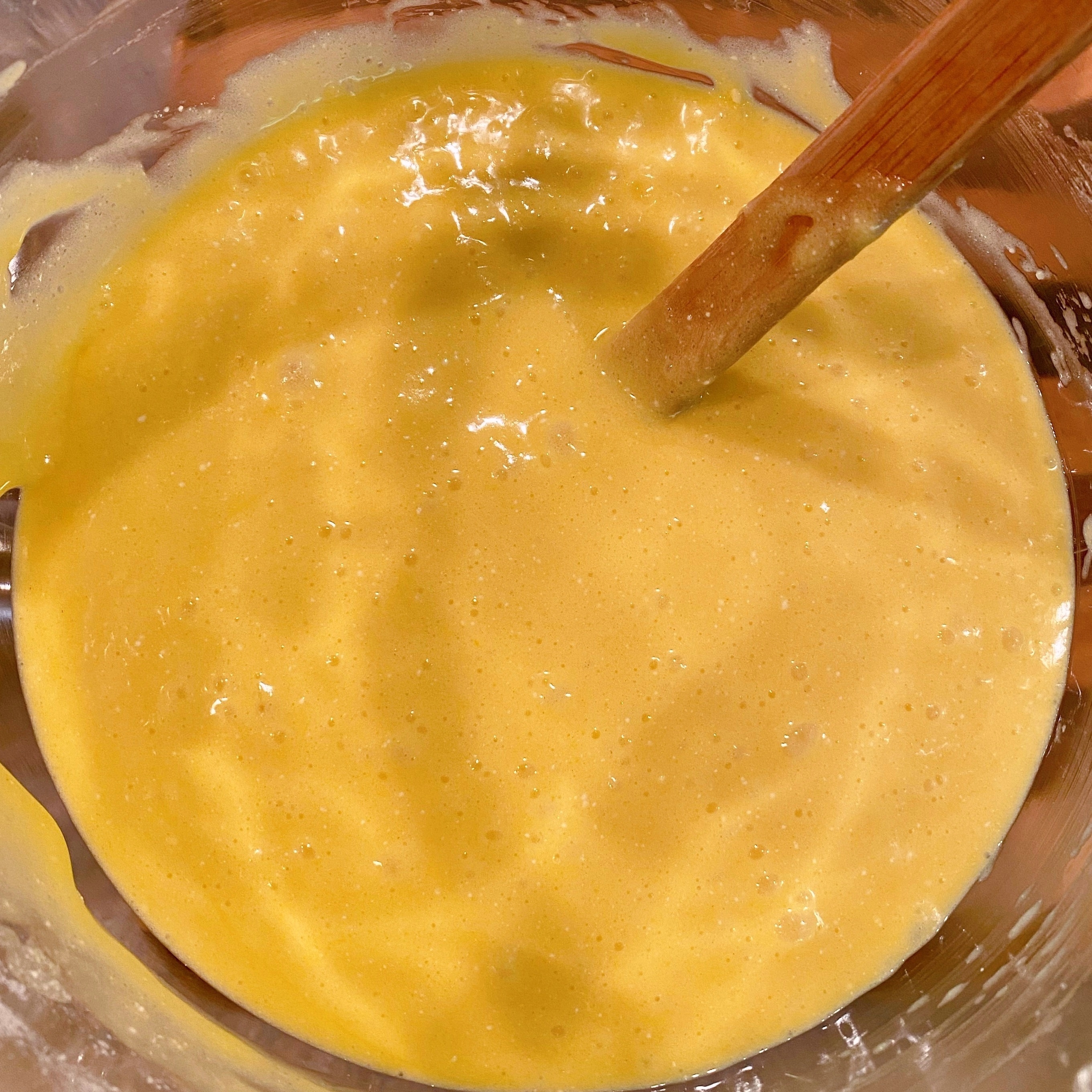 Cake mix batter in mixing bowl with spatula.