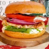 Up close photo of a Mediterranean Chicken Sandwich with dill sauce.