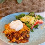 Cornbread Taco Chili Casserole Serving on blue plate with salad.