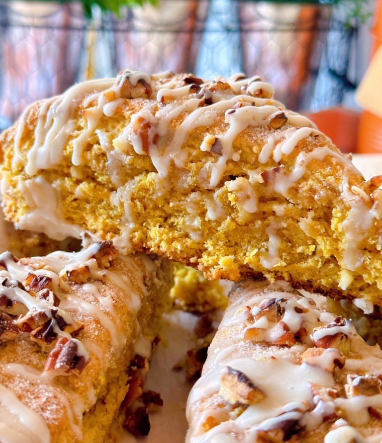 Oatmeal Pumpkin Scones with Maple Glaze with pecans stacked high.