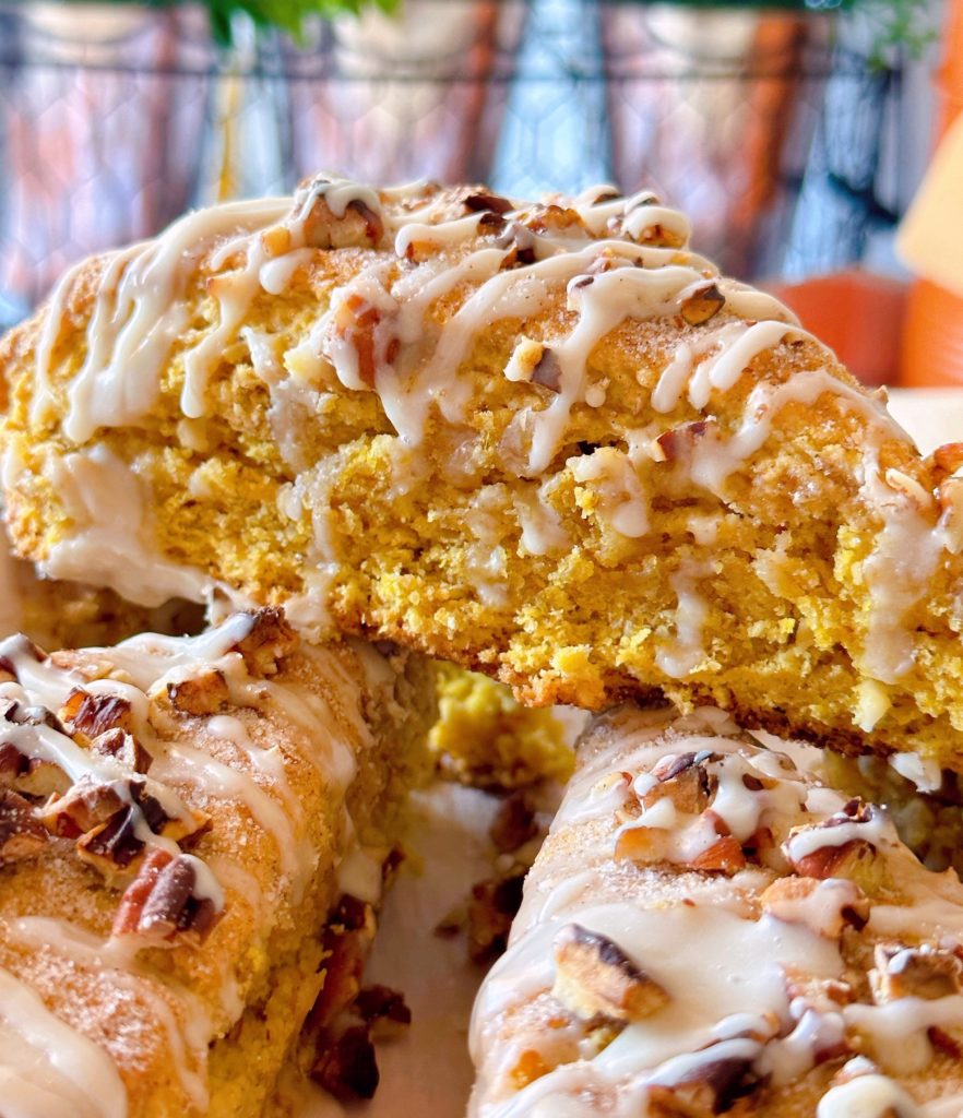 Oatmeal Pumpkin Scones with Maple Glaze with pecans stacked high.