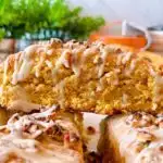Oatmeal Pumpkin Pecan Scones with Maple Glaze on a plate.