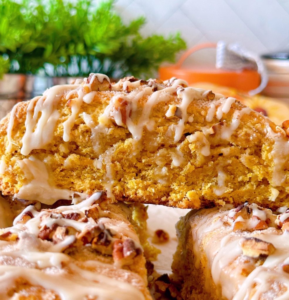 Oatmeal Pumpkin Pecan Scones with Maple Glaze on a plate.
