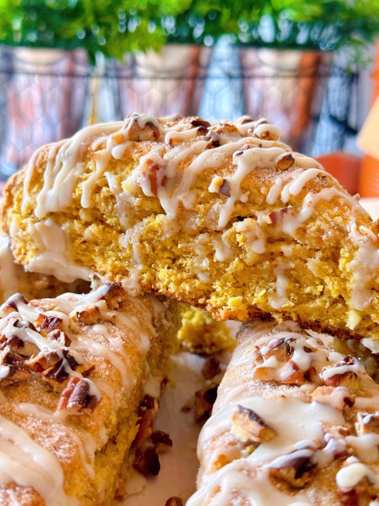 Oatmeal Pumpkin Scones close up with maple glaze drizzled on top.