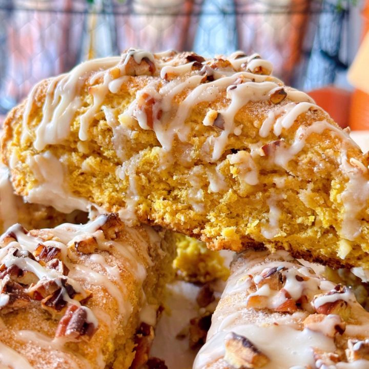 Oatmeal Pumpkin Scones close up with maple glaze drizzled on top.