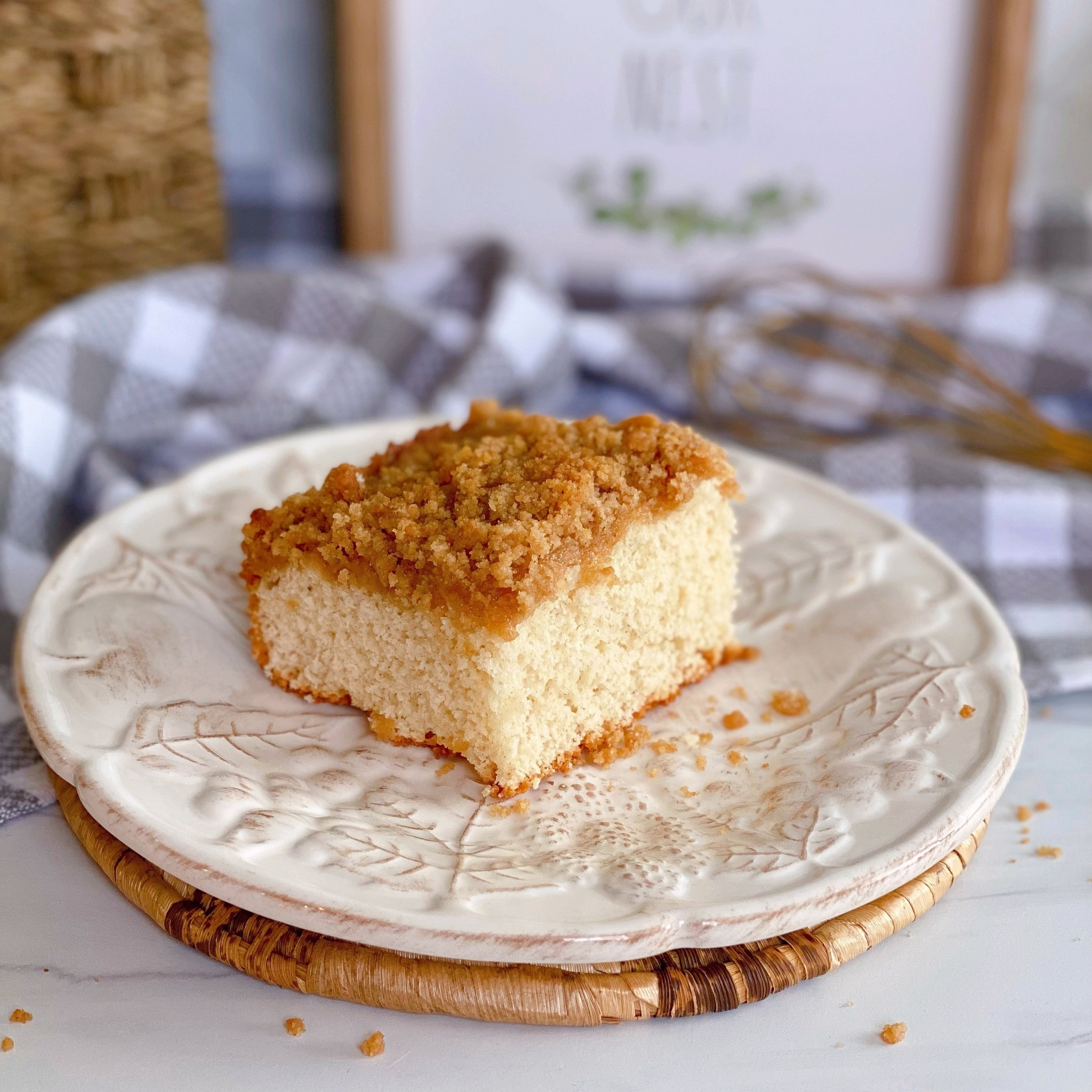 Piece of Original Bisquick Cinnamon Streusel Coffee Cake on a white plate.