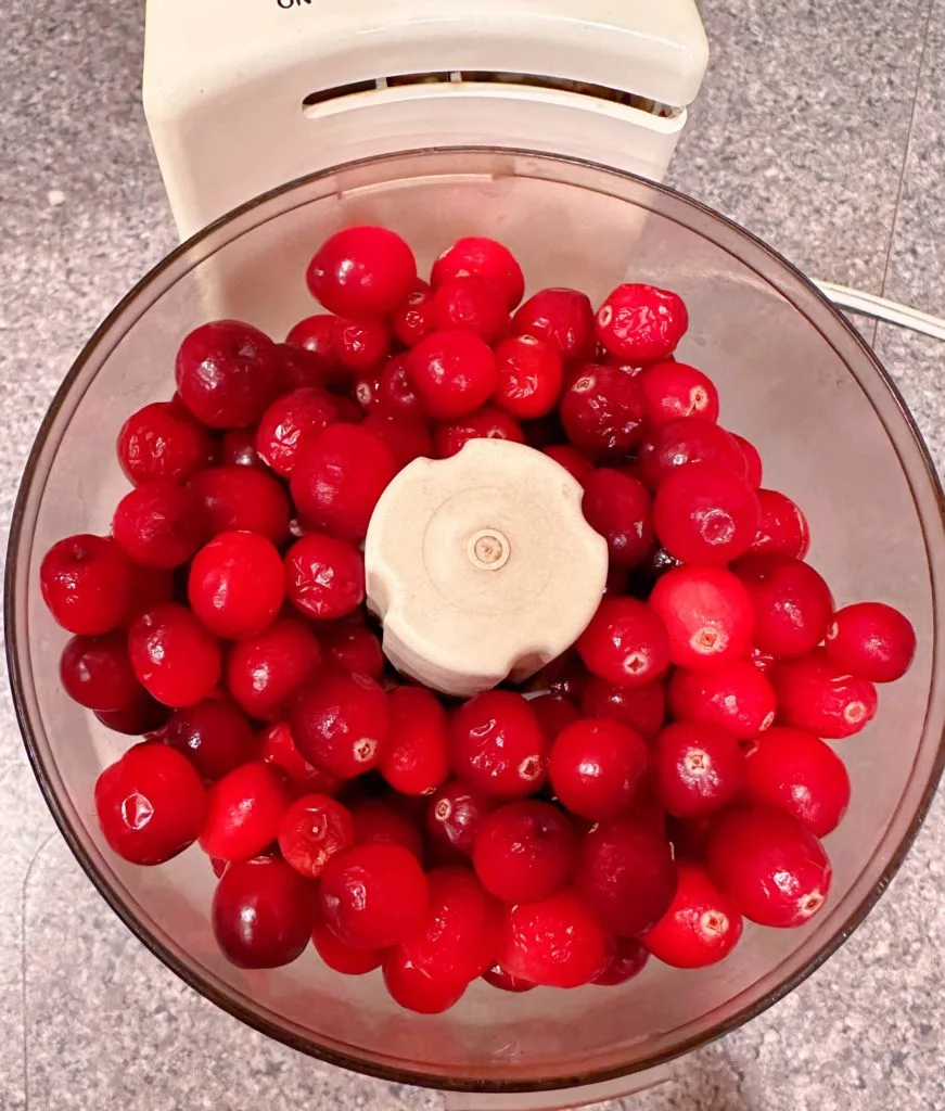 Cranberries in a food processor ready to grind.