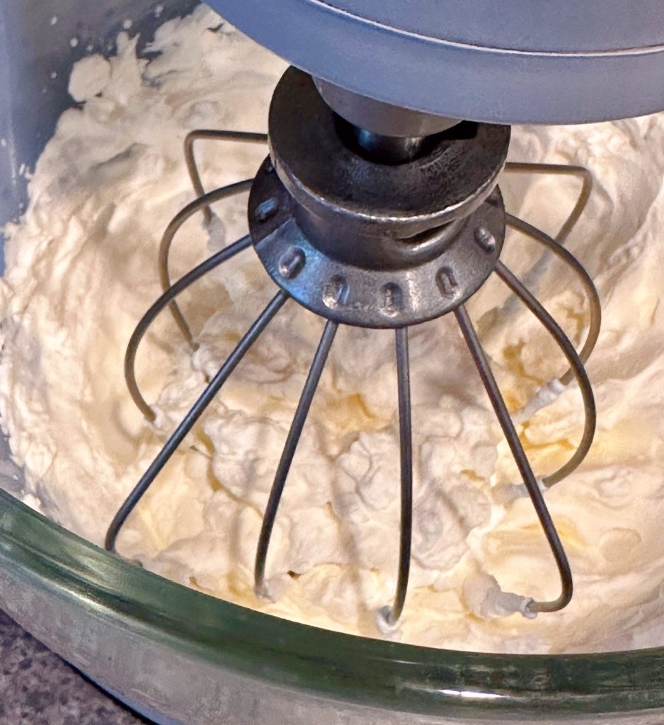 Whipped cream in mixing bowl.