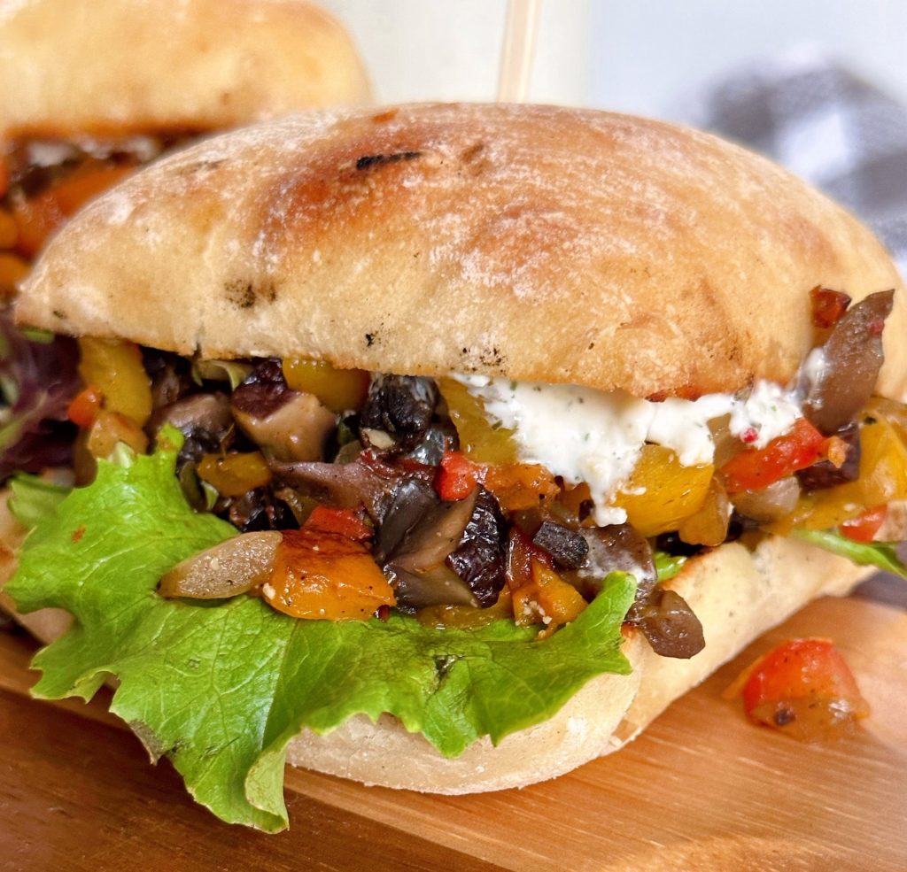 Greek Sandwich up-close on cutting board.