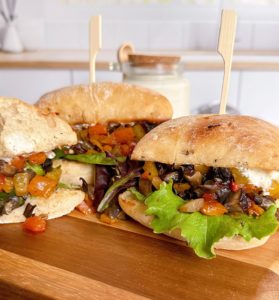Greek Portobello Sandwiches on a cutting board.