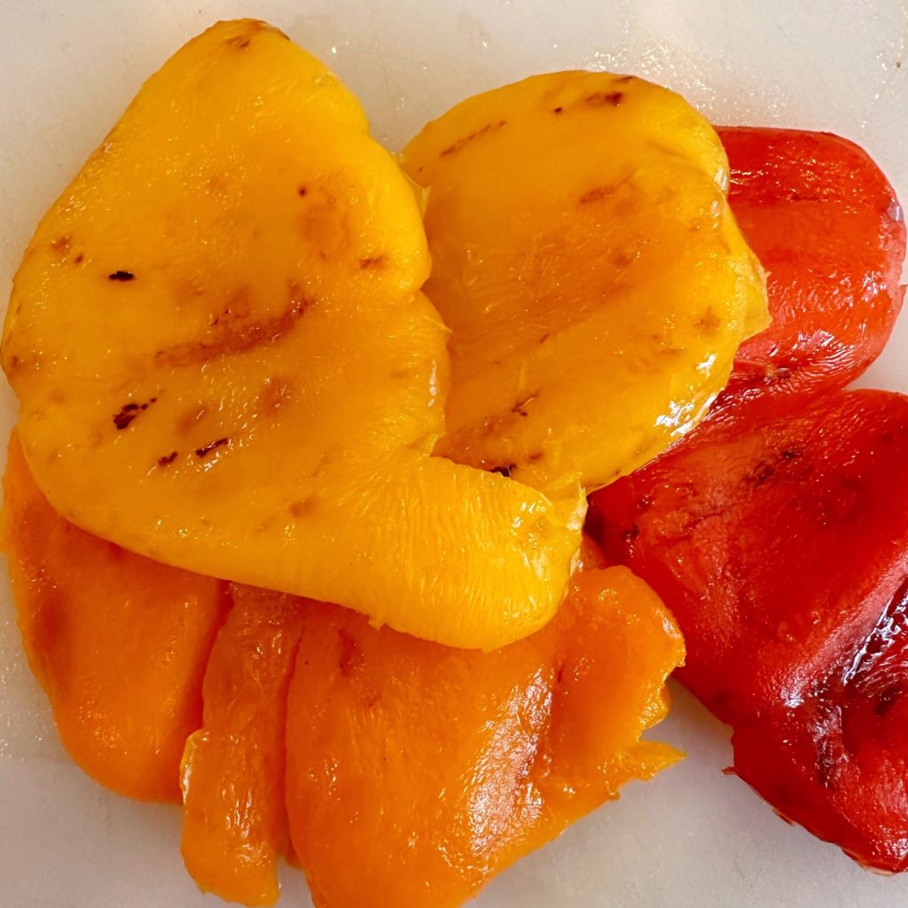 Peeled Peppers on a cutting board.