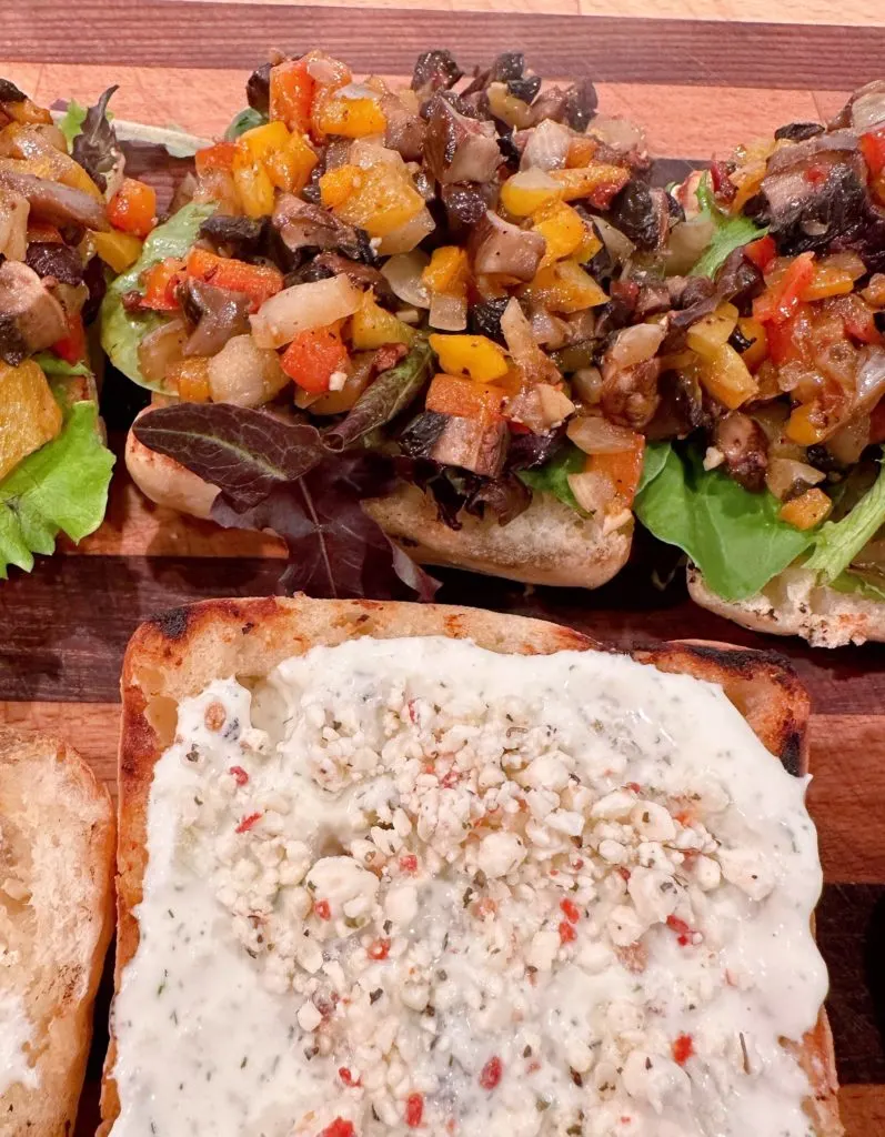 Mushroom mixture on top of each bed of spring mix.