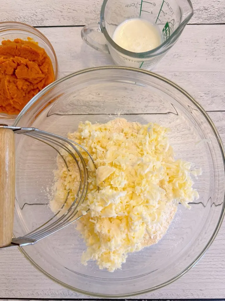 Flour mixture with grated frozen butter for biscuits.