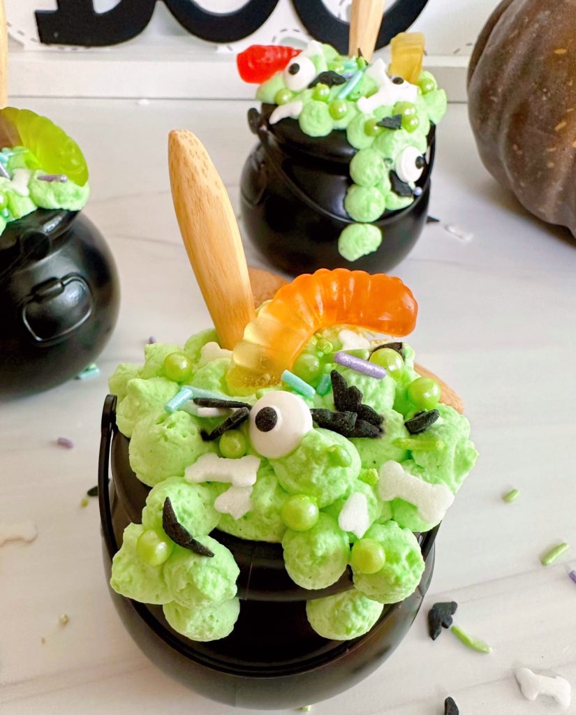 Close-up of each cauldron with candy worms and sprinkles.