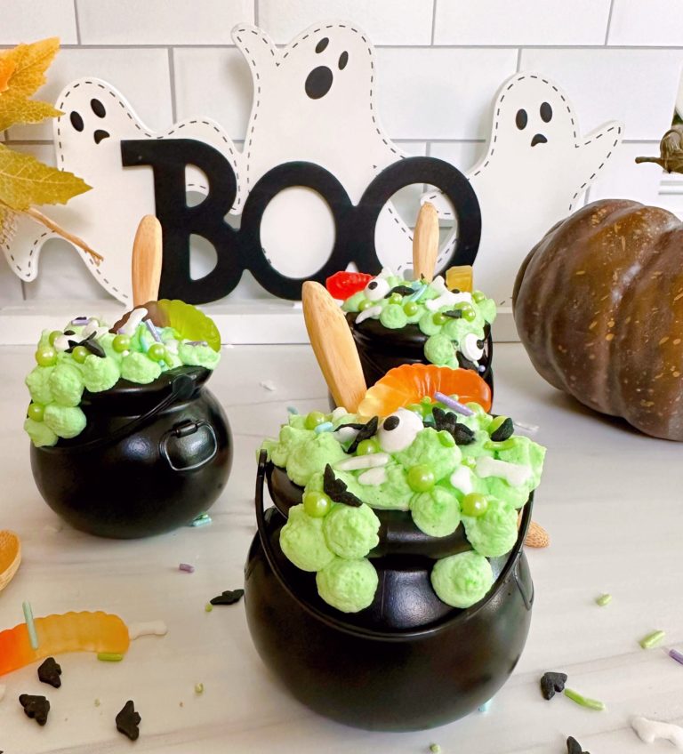 Halloween Witches Pudding cups with wooden spoons and candy bug sprinkles.
