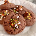 Chocolate Peanut Butter Blossom Cookies on a white serving plate.