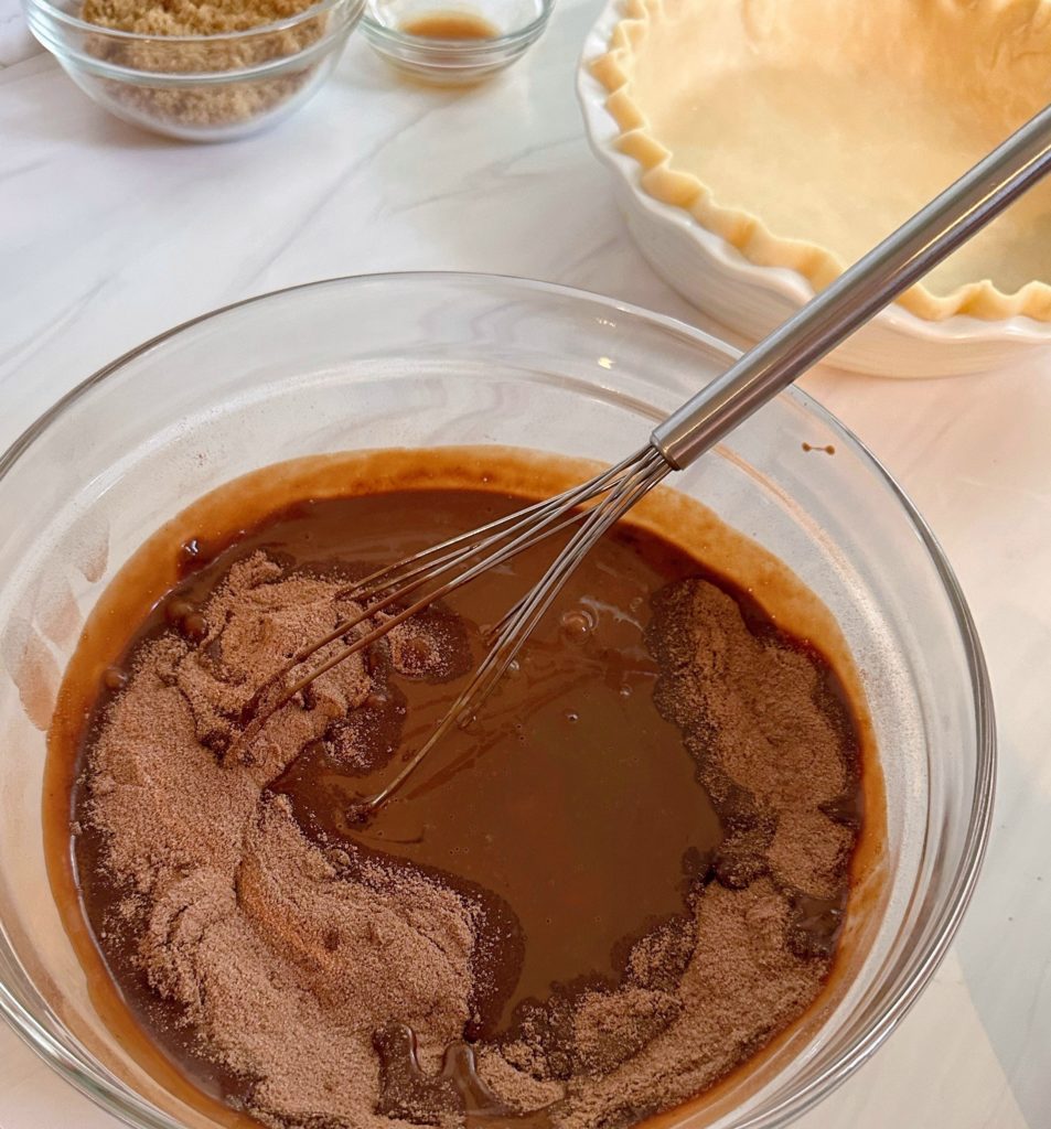 Adding Dry ingredients to wet chocolate ingredients.