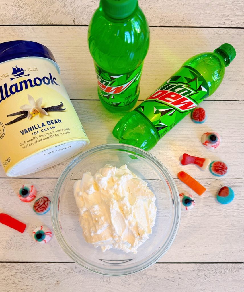 Ingredients for Monster Mountain Dew Ice Cream Floats on a white table.