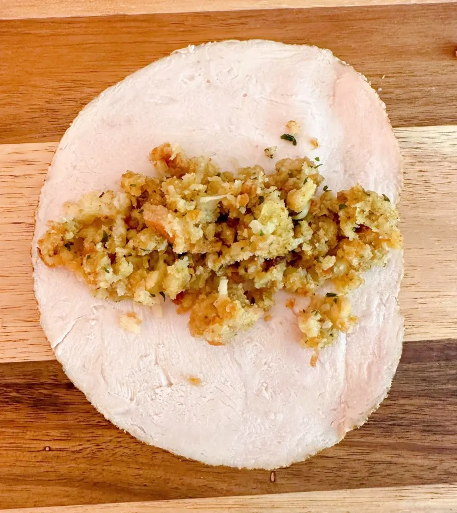 Stuffing being placed in the Turkey Rolls.