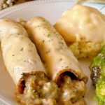 Turkey Roll-ups on a plate with mashed potatoes and vegetables.