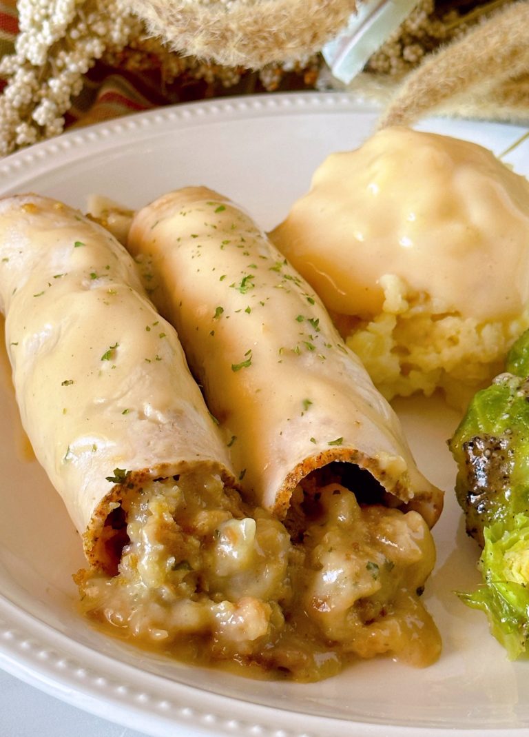 Turkey Roll-ups on a plate with mashed potatoes and vegetables.
