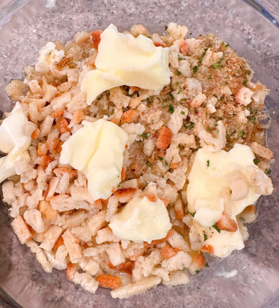 Stuffing mix with butter and water in a large microwave safe bowl.