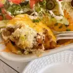 Serving Walking Taco Casserole out of the Baking dish.