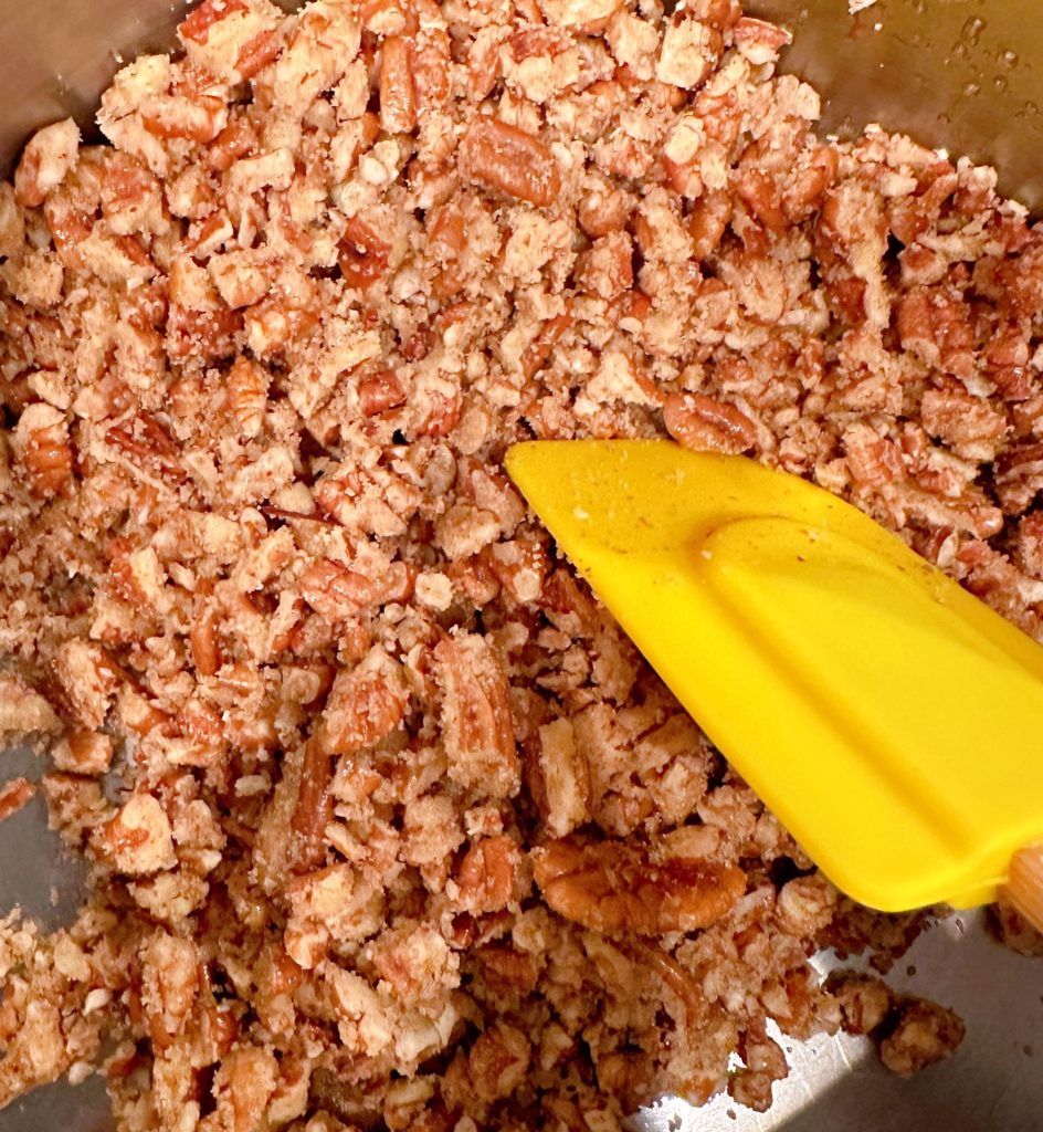 Candied coated pecans in a sauce pan.