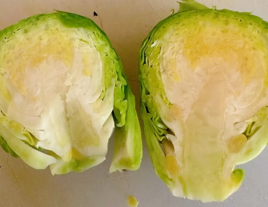 Brussels sprouts cut in half with the core removed.